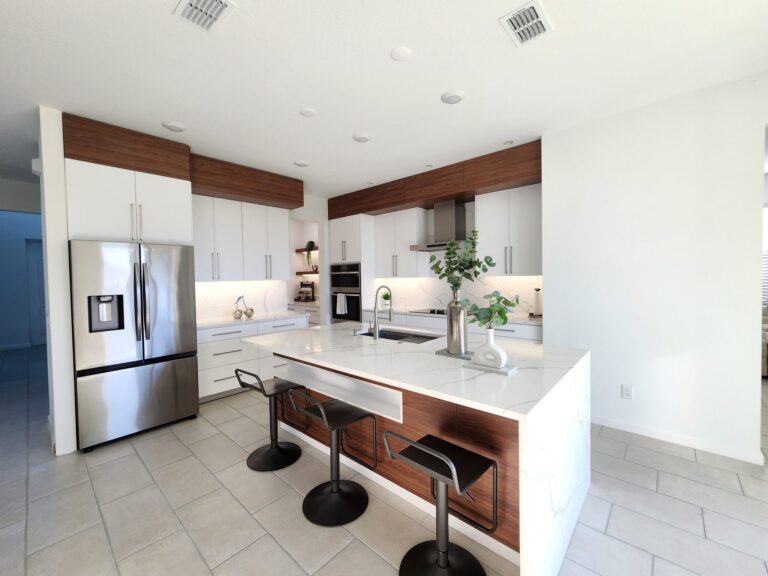 White kitchen wall cabinets with wood trim above a counter and range hood