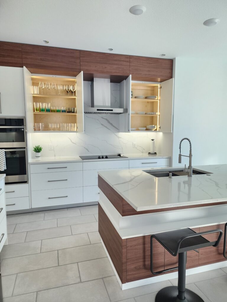 White upper kitchen cabinets and open wood display cabinets around a range hood