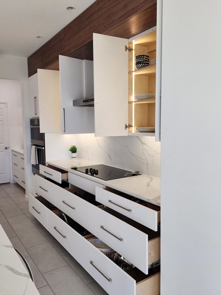 White wall cabinets with an open wood display cabinet beside a range hood
